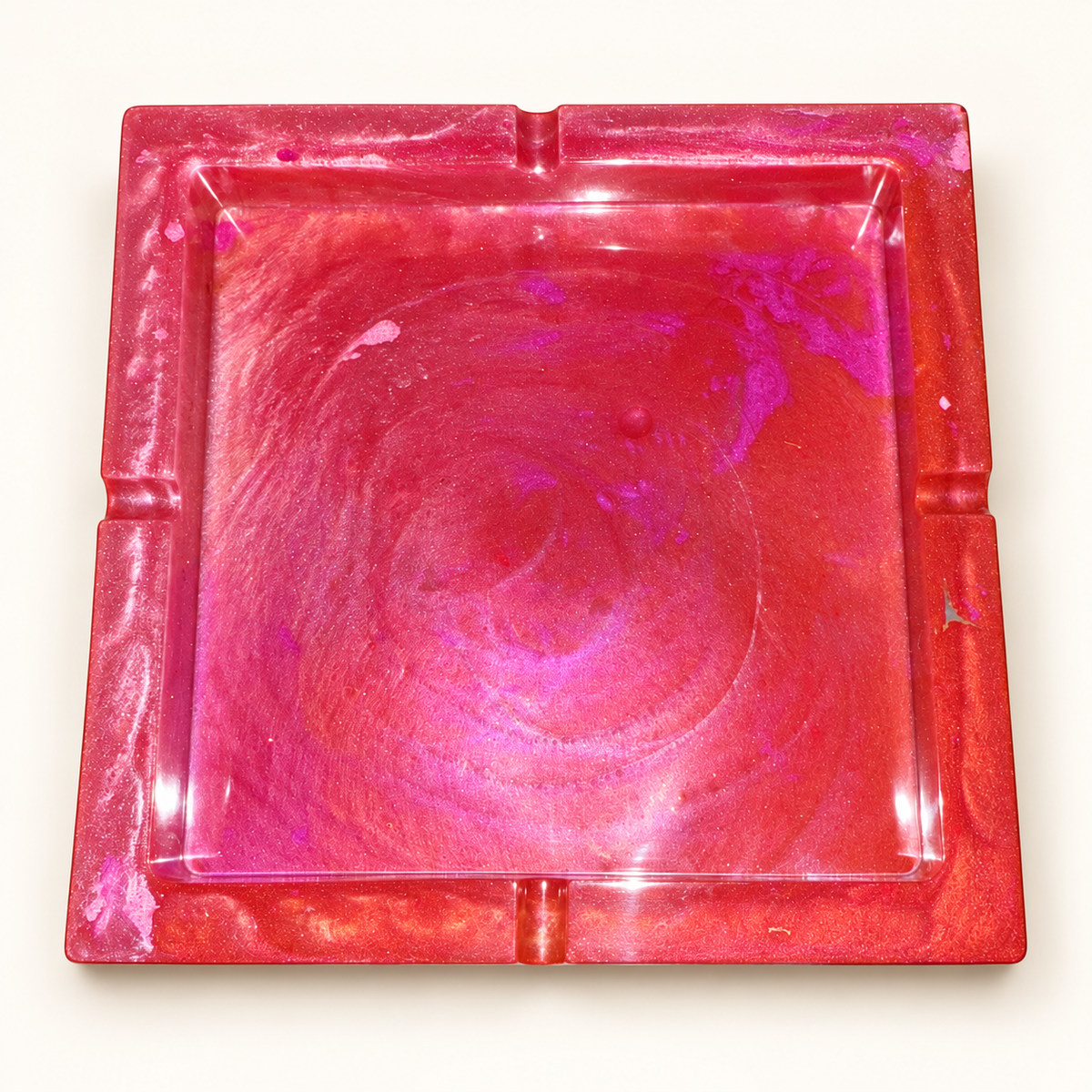 pink coral swirl large square resin ashtray with four notches on cream background