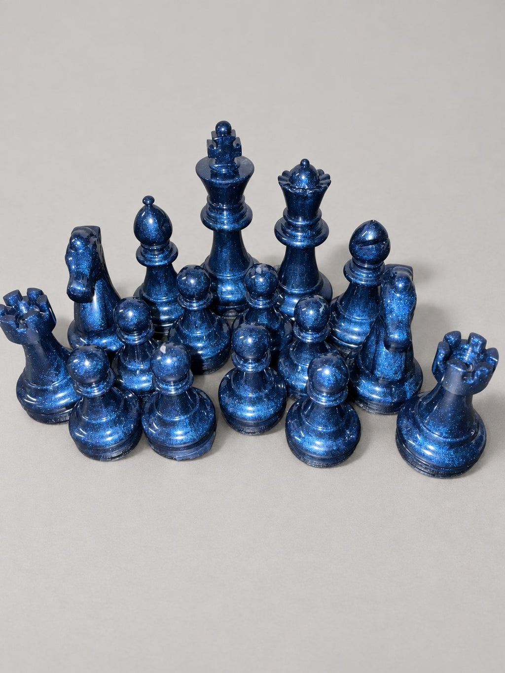 Navy blue shimmering handmade resin chess pieces close-up