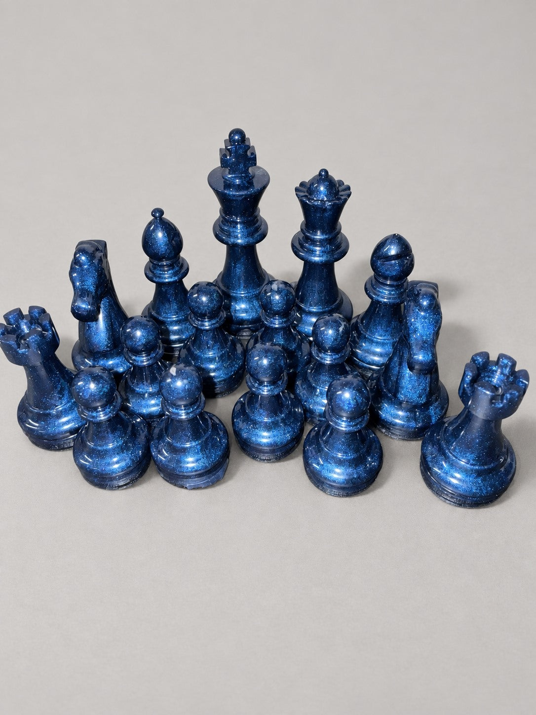 Navy blue shimmering handmade resin chess pieces close-up