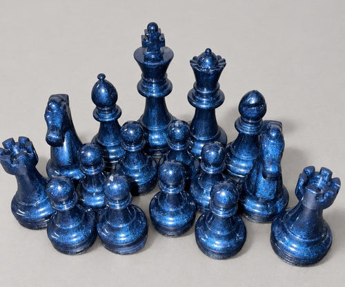Navy blue shimmering handmade resin chess pieces close-up