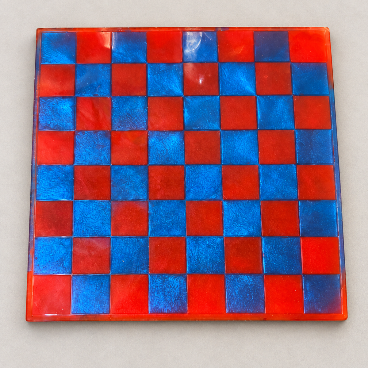 Red and blue resin chess and checkers board
