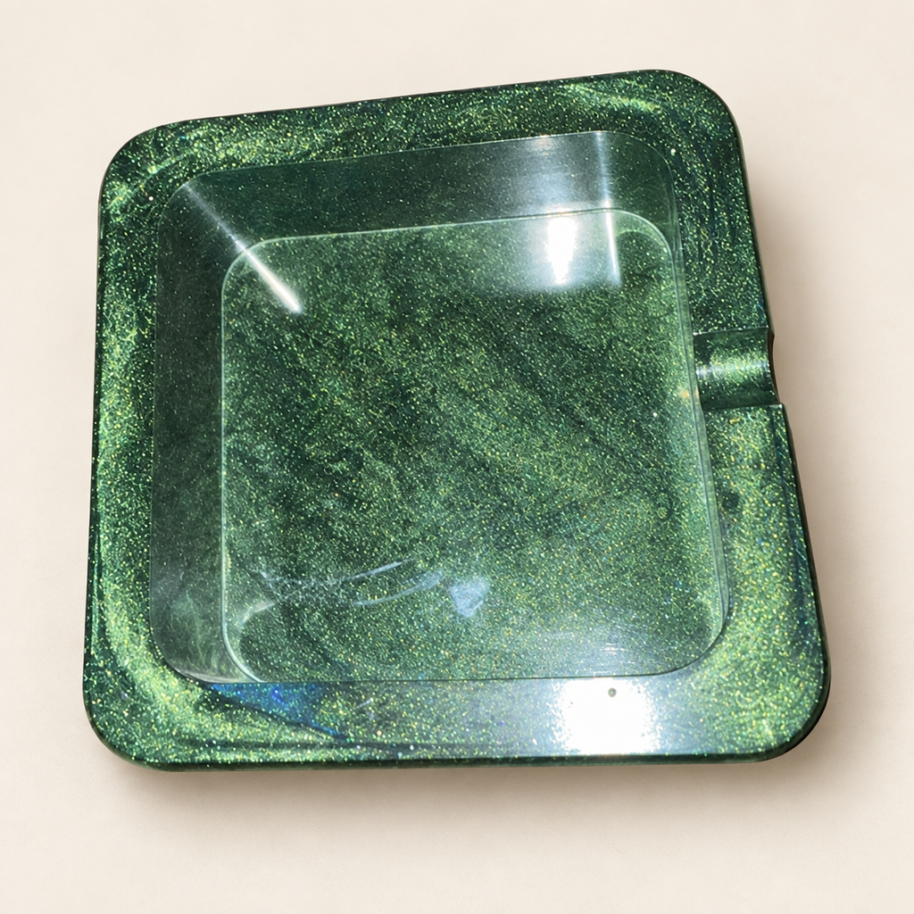 green shimmer small square resin ashtray with one notch on cream background