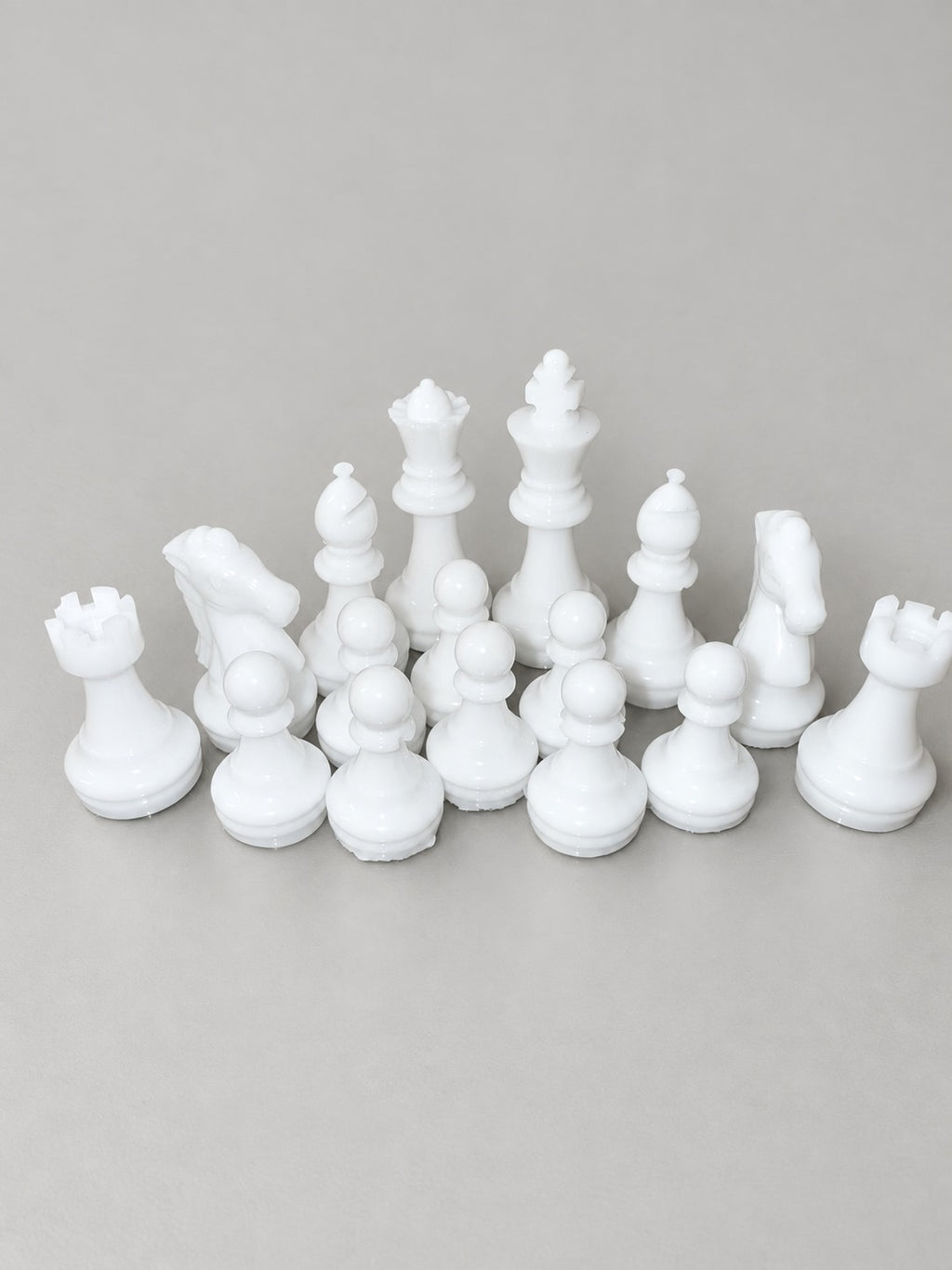 White handmade resin chess pieces close-up
