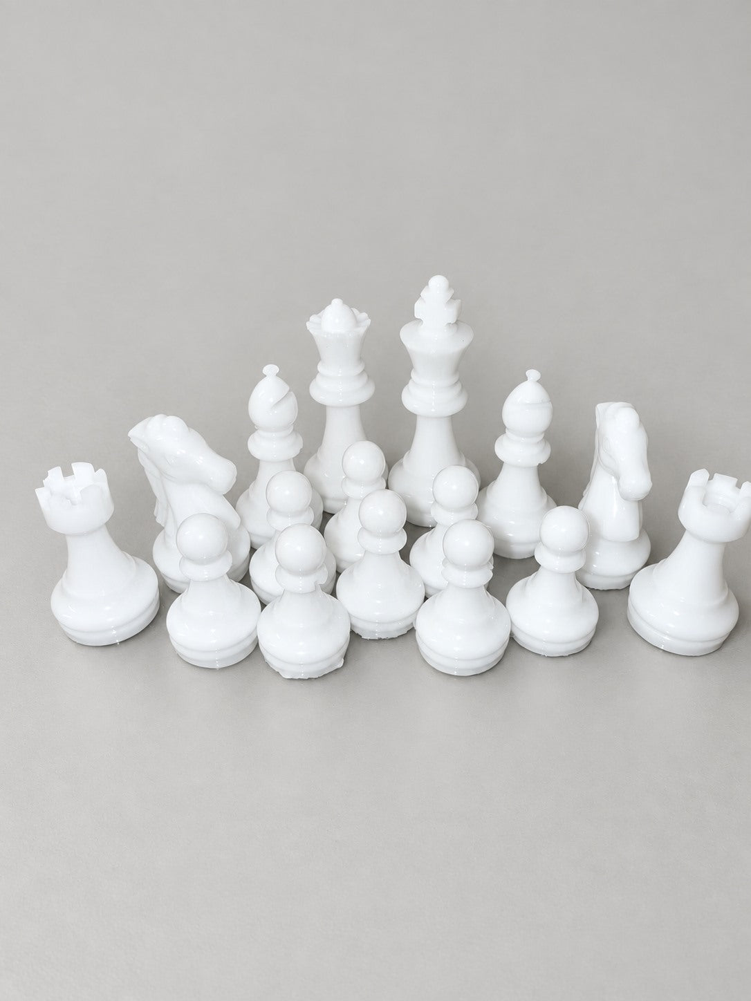 White handmade resin chess pieces close-up